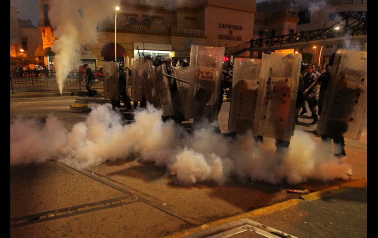 GUADALAJARA, JALISCO (02/ENE/2017).- Luego de que la mayoría de los manifestantes se retiraron de la calle, hombres con la cara cubierta comenzaron a lanzar botellas y piedras a los antimotines. EL INFORMADOR / F. Atilano