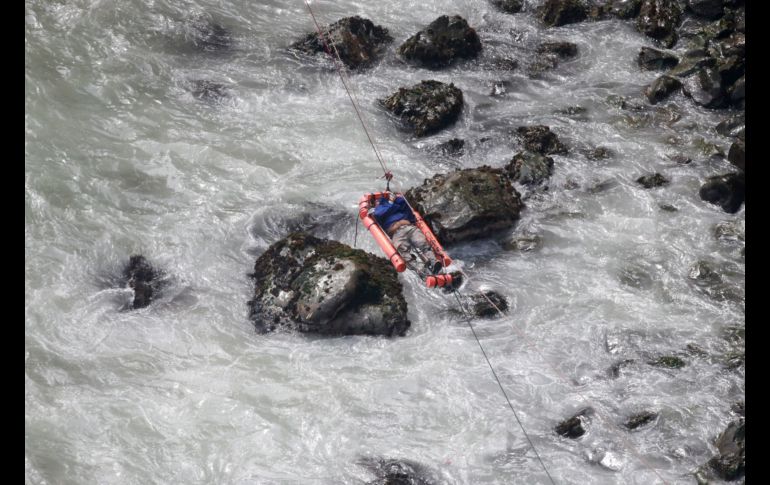 Un herido es trasladado sobre el agua en Pasamayo, Perú, luego de que un camión cayera a un abismo junto al mar. Al menos 36 personas murieron. AP/Andina/V. Tarky