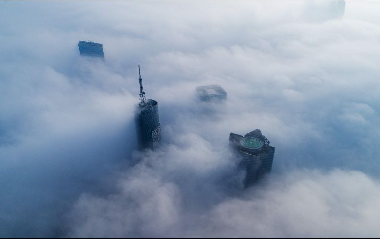 La niebla envuelve rascacielos en Hefei, en el este de China. AFP