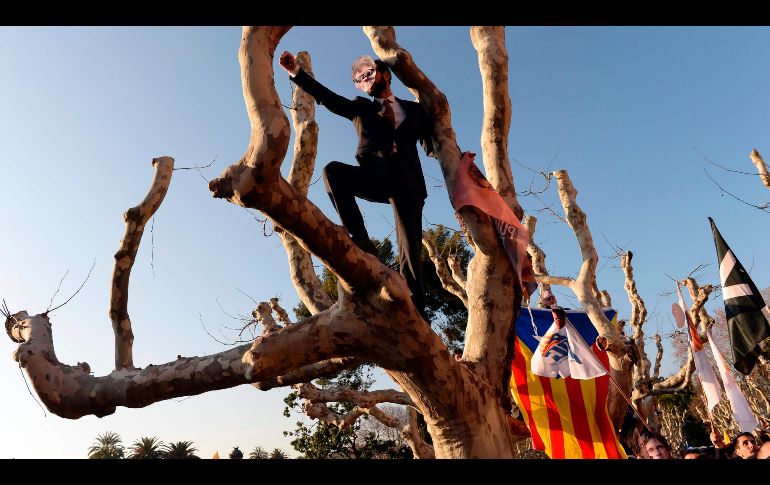 Un manifestante con una máscara de Carles Puigdemont, candidato a presidente de Cataluña, protesta afuera del Parlamento catalán. AFP/J. Lago