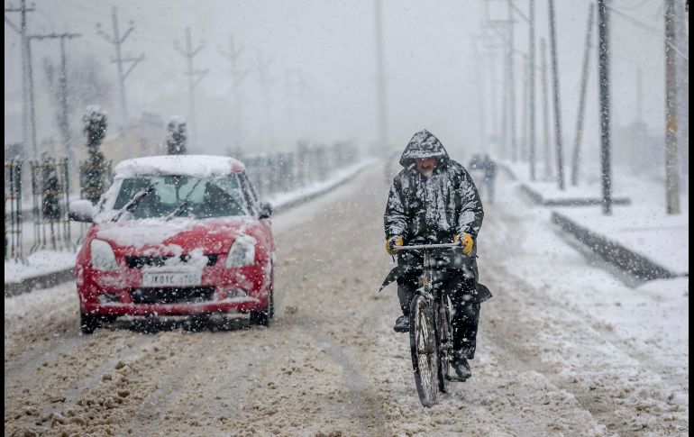 Un ciclista se traslada durante una nevada en las afueras de Srinagar, India. AP/D. Yasin