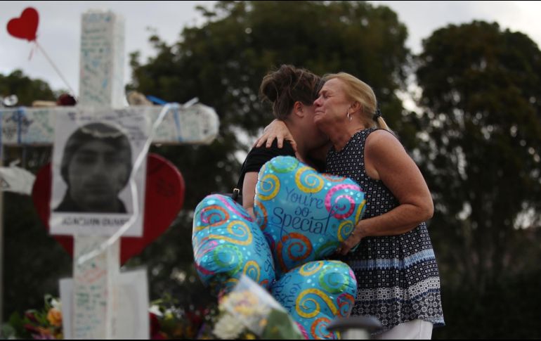 Residentes de Parkland, Florida, lloran en el memorial improvisado en recuerdo de las víctimas del ataque en la escuela Marjory Stoneman Douglas. AFP/J. Raedle