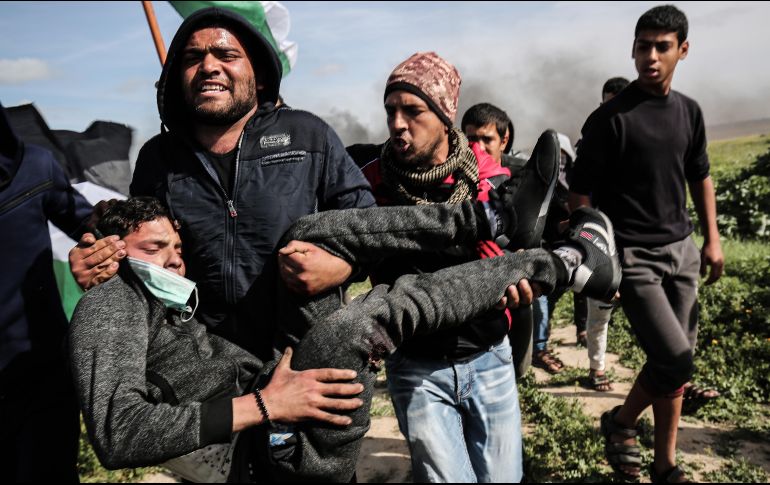Palestinos ayudan a evacuar a un herido durante enfrentamientos con tropas israelíes cerca de  Khan Yunis, por la cerca fronteriza entre Israel y la Franja de Gaza. AFP/S. Khatib