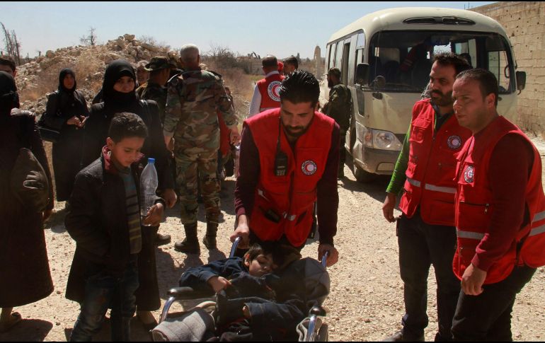 Personal médico atiende a los primeros civiles que salieron de Guta tras un acuerdo logrado por rebeldes sirios. AFP/SANA