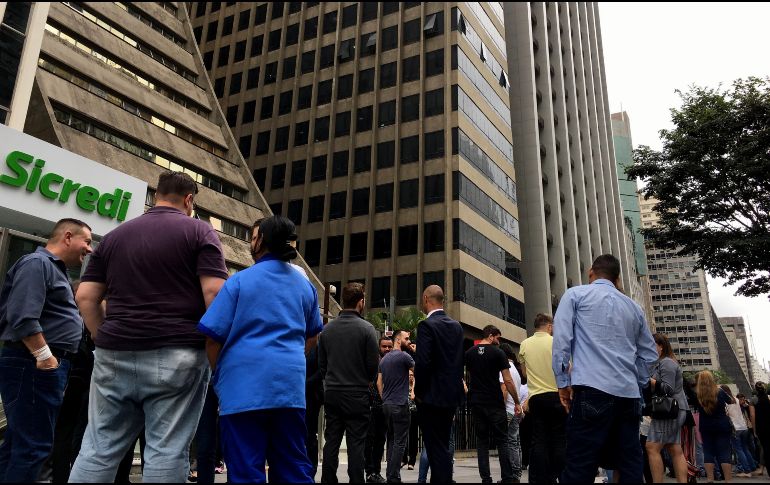 Personas evacúan los edificios ubicados junto a la avenida Paulista en Sao Paulo. EFE / F. Bizerra