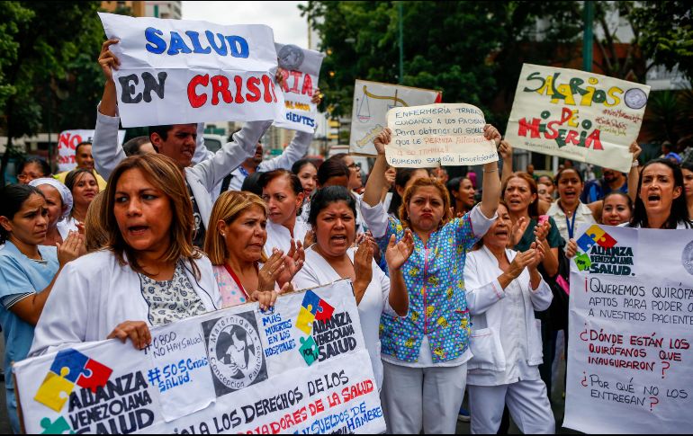 Con pancartas, banderas y batas blancas, los trabajadores salieron a las cercanías de los centros de salud. EFE / C. Hernández