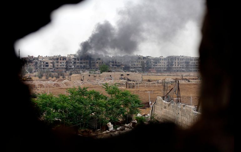Humo de bombardeos contra el Estado Islámico se ve en Damasco, Siria, en una imagen tomada durante un recorrido guiado por parte del gobierno. AFP/L. Beshara