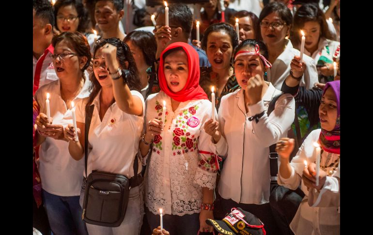 Un grupo de personas participan en una velada en honor a las víctimas de una serie de ataques de bomba en Yakarta, Indonesia. AFP / B. Isimoyo