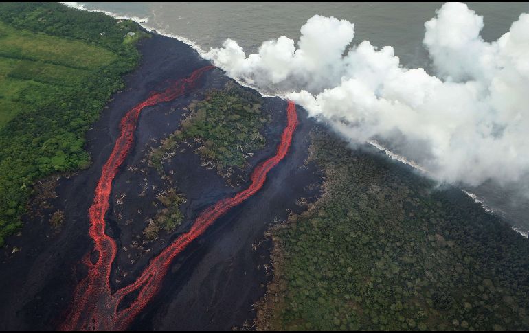 Una nube de vapor se eleva este lunes al entrar la lava en contacto con el Océano Pacífico cerca de Pahoa, en Hawái. AFP/M. Tama