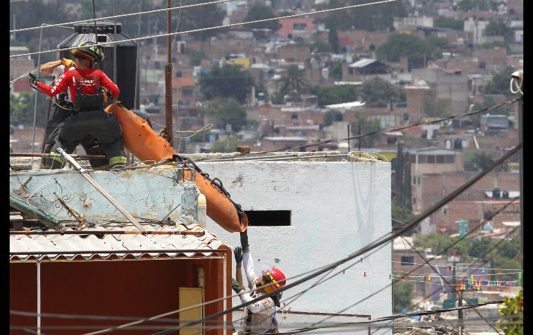 Forenses trasladan un cuerpo. AFP/U. Ruiz