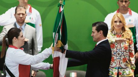 Abanderamiento. La tiradora tapatía Alejandra Zavala recibe el Lábaro Patrio de manos del Presidente. EFE