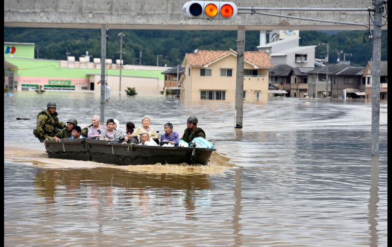Los equipos de emergencia de Japón continúan hoy las labores de rescate y la búsqueda de decenas de desaparecidos por las inundaciones y derrumbes causados por la lluvia torrencial en la mitad sur del país. Rescatistas trasladan a ancianos en un bote en Kurashiki.