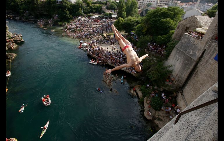 Un clavadista salta de un puente en Mostar, Bosnia, durante la competencia anual de clavados de altura. El llamado Puente Viejo se ubica 25 metros sobre el río Neretva y es un sitio patrimonio mundial de la Unesco. AP/A. Emric