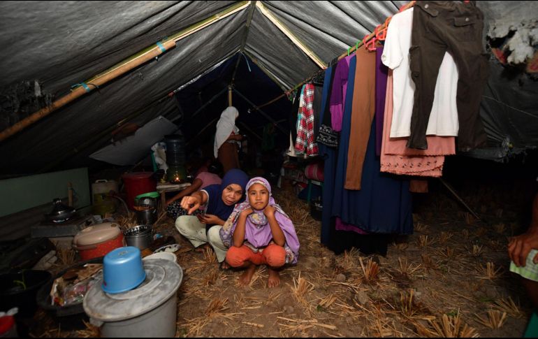 Sobrevivientes del sismo posan dentro de una de las improvisadas tiendas de campaña que les sirven como hogar. AFP/A. Berry