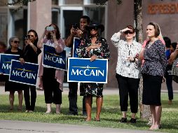 Habitantes de Arizona salen al paso de la caravana que transporta los restos del senador John McCain partiera del Capitolio estatal. AP / J. C. Hong