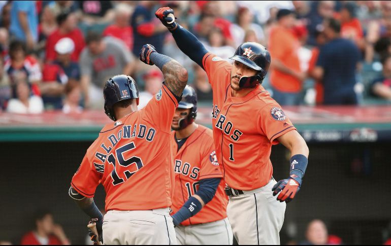 Carlos Correa (der.) conectó un cuadrangular de tres carreras en la octava entrada para asegurar que los Astros de Houston se mantenga con vida en estos Playoffs. AFP / G. Shamus