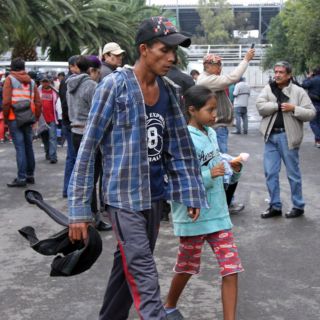Integrantes de caravana migrante descansan en estadio de CDMX