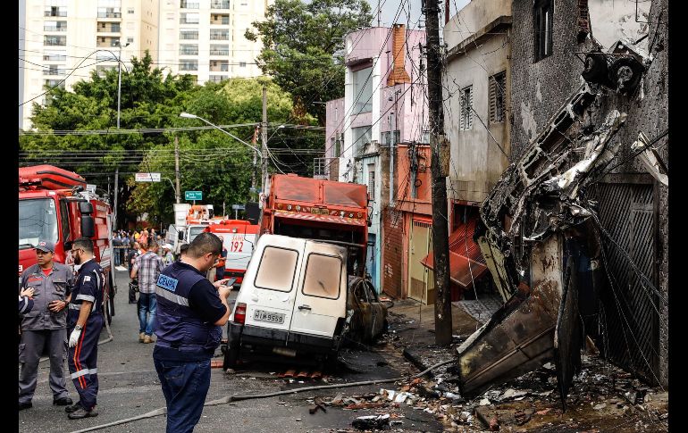Así quedó una calle tras estrellarse hoy una pequeña aeronave en la zona norte de Sao Paulo, Brasil. Al menos dos personas murieron y doce resultaron heridas luego de que el aparato impactó contra algunas residencias privadas y vehículos que estacionados. EFE/M. Chello