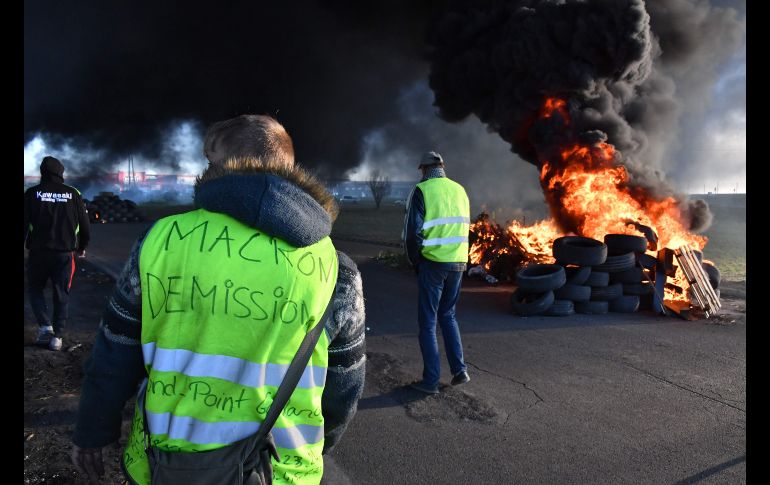 Manifestantes bloquean una carretera en Aimargues, Francia. En el chaleco se lee 