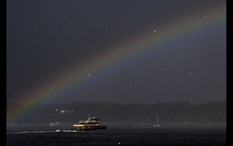 Un ferri navega junto al arcoíris durante una tormenta en Sídney, Australia. EFE/B. Esposito