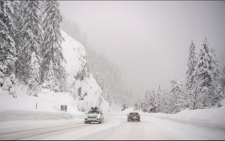 A lo largo de las carreteras, varios vehículos atrapados entre la nieve se alcanzaban a vislumbrar como parte del paisaje. EFE/C. Bruna