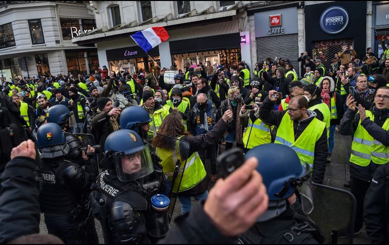 Las marchas se desarrollaron en medio de una amplia presencia policial y pese a las bajas temperaturas. AFP/L. Venance