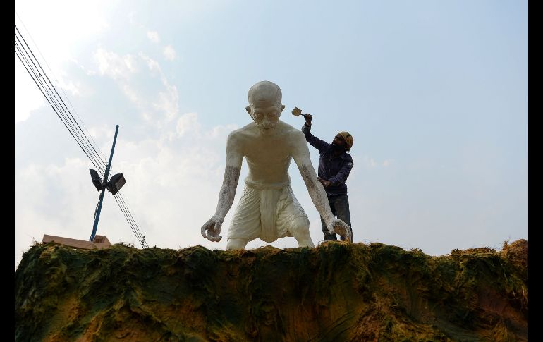 Un trabajador pinta en Nueva Delhi, India, una estauta de Mahatma Gandhi que se usará en un desfile del Día de la República, a celebrarse el 26 de enero. AFP/S. Hussain