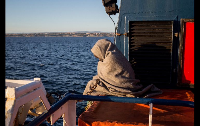 Un migrante aguarda en la embarcación de la organización civil Sea Watch 3 cerca de la costa de Sicilia, Italia. El barco se dirige a Catania para desembarcar a 47 migrantes rescatados luego que Francia, Italia, Alemania, Malta, Portugal, Rumania y Luxemburgo accedieron a acogerlos. AFP/F. Scoppa