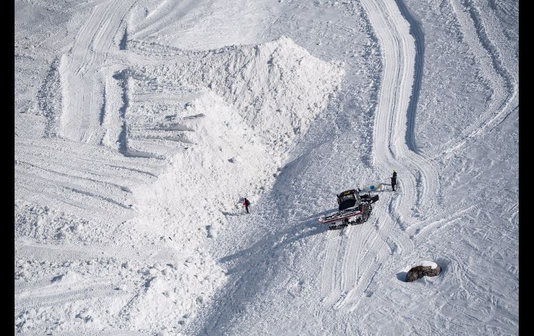 Miembros de los servicios de rescate buscan víctimas en el lugar donde ayer se produjo una avalancha, en la estación de esquí de Crans-Montana, Suiza. Entre 10 y 12 personas quedaron atrapadas y se encuentran desaparecidas. EFE/J. Bott