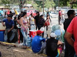 Cientos de personas hacen filas para llenar envases con agua de pozos subterráneos, en tanto que unos 50 camiones cisterna la reparten a zonas más alejadas. EFE/R. Martínez
