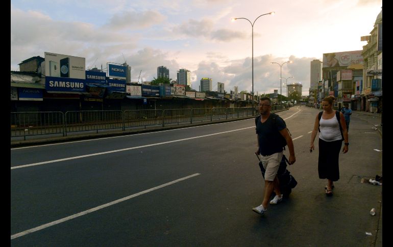 Turistas caminan por una calle en Colombo. Tras las ocho explosiones, el Gobierno ha decretado el estado de emergencia y la policía ha impuesto el toque de queda con efecto inmediato ante el temor a nuevos ataques.