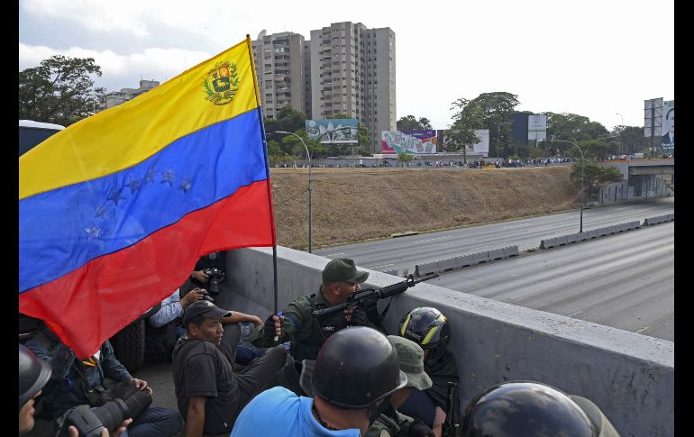 Militares que apoyan a Guaidó se colocan en posición frente a la base La Carlota. AFP/Y. Cortez