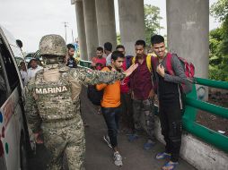 Migrantes de India, Pakistán y Bangladesh esperan en un cruce fronterizo en Tapachula. AP
