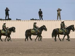 Vigilancia. Miembros del Servicio Secreto de Estados Unidos y agentes a caballo de la U.S. Border Patrol, en una de las escenas más frecuentes en la frontera. AFP
