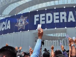 Elementos de la Policía Federal muestran sus credenciales durante la protesta en las instalaciones de la corporación en la Ciudad de México. NTX/I. Hernández