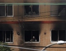 Bombero realiza labores de limpieza tras apagar el siniestro. EFE