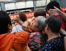 La gente tuvo que esperar casi dos horas para pagar sus compras o tres para estacionar su vehículo y acceder a la tienda. AFP