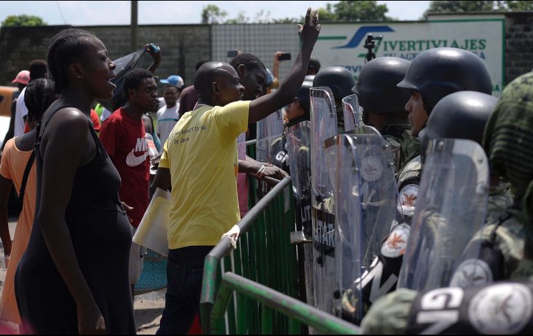 Migrantes de origen africano protestan frente a miembros de la Guardia Nacional en la garita migratoria Siglo XXI, en Tapachula. EFE/C. López