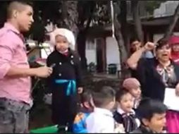 En la grabación se observa a un pequeño disfrazado de Miguel Hidalgo y Costilla, subido a una mesa y rodeado de maestros y otros menores. ESPECIAL