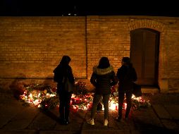 Personas visitan un memorial en honor a las víctimas del tiroteo, ocurrido durante la fiesta religiosa del Yom Kippur. AFP/R. Hartmann
