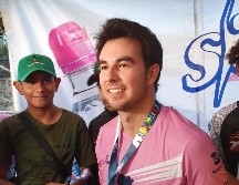Sergio Pérez deja su auto para ajustarse los tenis y participar en el recorrido celebrado en la Glorieta de La Minerva. EL INFORMADOR / M. Navarro