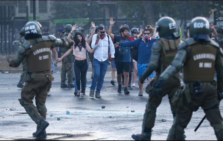 Manifestantes se enfrentan a carabineros mientras se registran diversas protestas en contra del Gobierno, demandando mejoras sociales en Santiago. EFE/A. Valdes