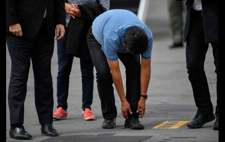 Morales se detuvo un momento para abrocharse un zapato. AFP/P. Pardo
