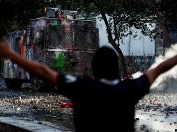 Un grupo de asaltantes aprocechó el caos de la manifestación para robar 200 mil dólares de un banco. ARCHIVO / EFE