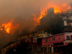 El Cuerpo de Bomberos de Valparaíso se desplegó en la zona para contener las llamas, además de recibir el apoyo de la unidad aledaña de Viña del Mar y otros cuerpos vecinos. AFP/R. Zamora-ATON CHILE
