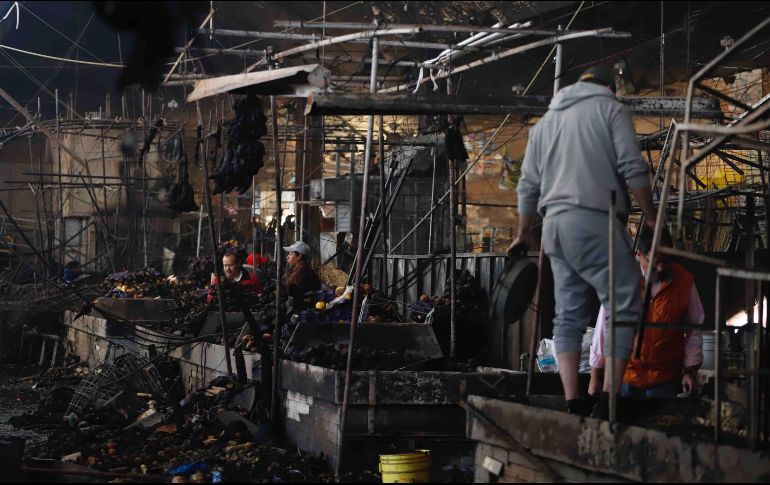 Locatarios del mercado de La Merced limpian y rescatan la mercancía que no se quemó luego del incendio registrado la noche de este 24 de diciembre. SUN/B. Fregoso