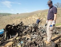 Expertos analizan la zona en donde se estrelló el helicóptero. AP/J. Anderson