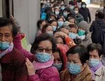 Personas hacen fila hoy para comprar mascarillas en una tienda en  Hong Kong. AP/Kin Cheung