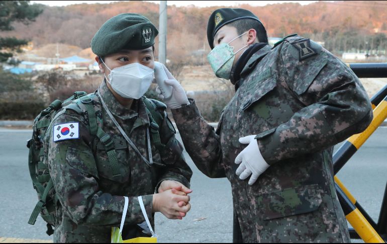 Un centinela le toma la temperatura a un soldado a la entrada de una unidad del Ejército como parte de las acciones para evitar la propagación del coronavirus en la ciudad de Goyang, Corea del Sur. EFE/YONHAP