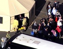 Captura de video que muestra a varios pasajeros abordando un autobús luego de desembarcar del crucero. AP/KGO-TV